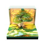 3D art calendar with realistic green tree design in paper cube shape, with LED light and loose leaf function. This desktop decoration is suitable for use as a note-taker and business gift.